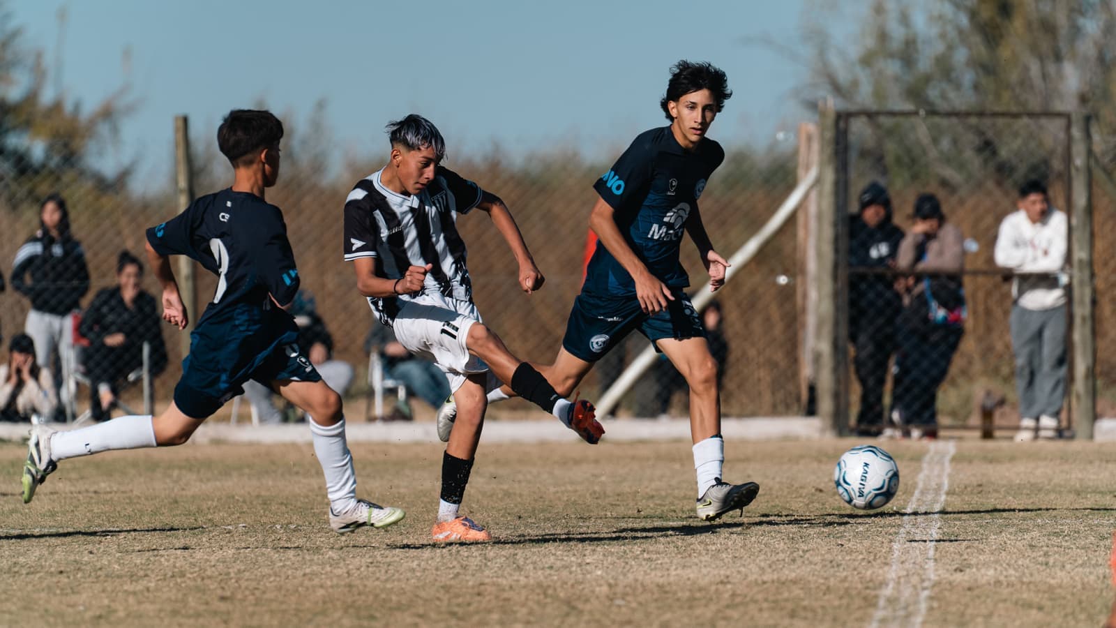 Players in motion during a youth soccer match on grass